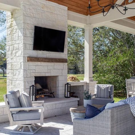 This Patio Retreat Finds Shelter Under a Charming Pergola | HGTV Outdoor Kitchen With Bar, Kitchen With Bar, Grill Patio, Modern Outdoor Fireplace, Outdoor Stone Fireplaces, Covered Outdoor Kitchens, Fireplace Outdoor, Outdoor Sitting, Covered Patio Design