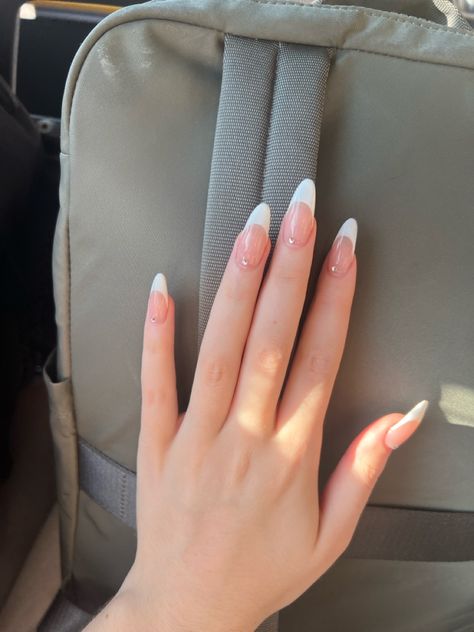 french tip inspo w gems Almond Shaped Nails With Gems, French Tip With Stones Nail Design, Low French Tip Nails Almond, Gems On French Tips, Simple Nail Designs With Charms, White French Tip With Jewels, French Tip White Almond, Alomd Nails Cute French, French Nails With Gems Rhinestones