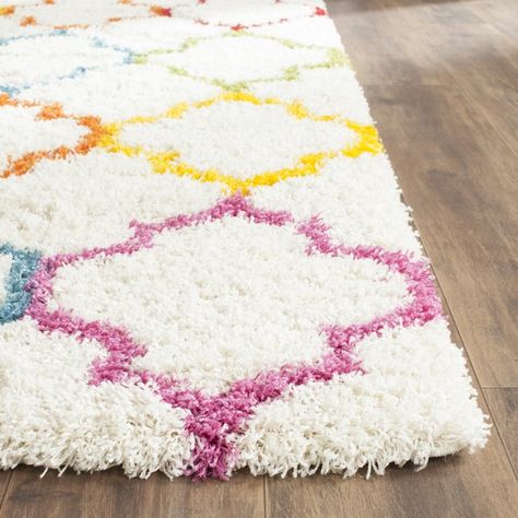 A classic quatrefoil motif pairs with multicolor hues to round out the eye-catching Kids Ivory Shag Area Rug, a distinctive addition to your decor. Use it to anchor your little one's room in traditional style then pair it with a charming floor lamp for a dynamic look. Round out the arrangement with framed prints for an artful display. The rug's understated design makes it blend effortlessly into any ensemble, from beachy coastal-chic to crisp contemporary. Use it to level out handsome... Flokati Rug, Carpets For Kids, Fur Carpet, Rainbow Rug, Brown Carpet, Shag Carpet, Trellis Rug, Kids Bedrooms, Wall Carpet