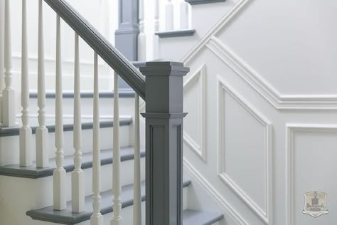 White and gray staircase boasts a gray handrail and steps as well as a white spindles. Grey Banister White Spindles, White And Grey Bannister, Painted Handrail, Grey Painted Stairs, Stairway Wainscoting, Gray Stairs, White Staircase, White Stairs, Wainscoting Bedroom