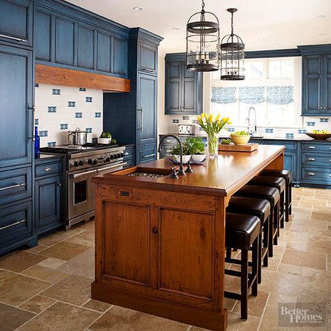 Texture rules this kitchen. The stained-wood island showcases knots and grain of the wood, adding warmth to the deep blue outer cabinets. A plank of matching wood above the range ties the room together. Contrasting Kitchen Island, Blue Kitchen Island, Small Kitchen Island, Blue Kitchen Cabinets, Farmhouse Kitchen Island, Kitchen Island With Seating, Brown Kitchens, New Kitchen Cabinets, Blue Cabinets