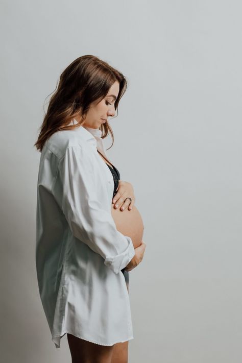 When Rachel emailed us she was expecting and wanted to do a Vogue-inspired maternity shoot, we were so excited. The looks that Rachel chose were classic and chic – a sleek black turtleneck, a white button down shirt, and a pair of hoop earrings. The simplicity allowed this mom-to-be to really shine. She looks elegant, timeless, and completely stunning. Jeans And Shirt Maternity Shoot, White Polo Maternity Shoot, Dress Shirt Maternity Shoot, White Button Down Shirt Outfit Maternity, Maternity Pictures Jeans And White Shirt, Maternity Photos White Shirt, Button Down Shirt Maternity Shoot, Classic Maternity Photos, Maternity Photos Button Down Shirt