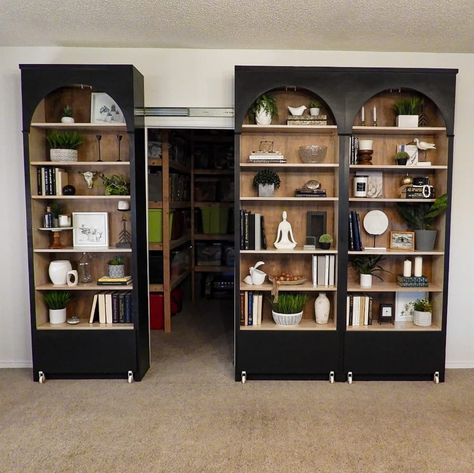 Black painted Ikea Billy bookcase filled with books and other objects opened to show storage space behind. Bookcase Door Diy, Ikea Entertainment Center, Ikea Decor Hacks, Billy Bookcase With Doors, Ikea Billy Hack, Living Room Hacks, Ikea Organization Hacks, Ikea Desk Hack, Home Office Shelves