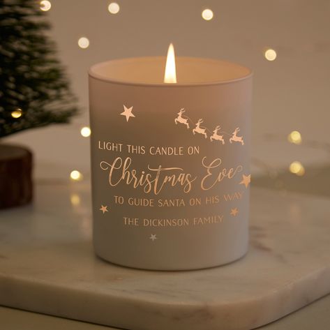 A fun Christmas candle, perfect to add to your Christmas Eve traditions! The text reads 'Light This Candle on Christmas Eve to Guide Santa on His Way' with room for your family name too. Festive stars and a reindeer feature on the candle, and when lit the candle light glows through the etching for a wonderful effect. Our personalised candles are filled with a scented natural wax that burns for up to 40 hours. The glass has a matt white finish whilst the engraved part is clear so that the candle Personalised Candles, Christmas Eve Traditions, Candle Picture, Christmas Scented Candles, Festive Treats, Candle Light, Custom Candles, Personalized Candles, Cricut Creations