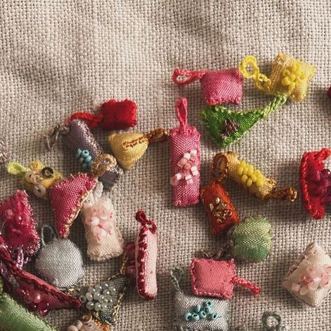 Antonia  Rossi on Instagram: "Tiny charms to carry with you at all times  #charms #embroidery #embroidered #love #protection #luckycharm #portebonheur #silk #collection" Tiny Charms, Embroidery Accessories, Vintage Sewing Notions, Tiny Charm, Textile Jewelry, Slow Stitching, Fabric Beads, Bead Jewellery, Fabric Jewelry