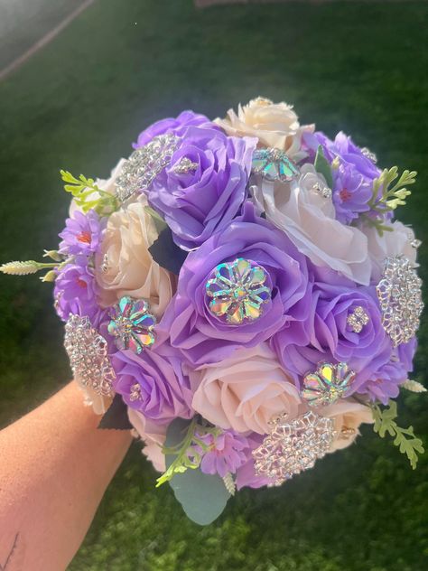 Handmade Quinceañera Bouquet/ Wedding. With Lilac and Ivory Roses. Finished off with Iridescent brooches. *Please note brooches can change in style due to availability.* Decor / color combinations can be changed upon request. {This is a made to order Bouquet} Purple Quince Ramo, Quince Bouquet Purple, Quinceanera Bouquet Purple, Purple Quince Bouquet, Gold Quince Dress, Purple Quince, Quinceanera Bouquet, Pink Quince, Quinceanera Themes Dresses