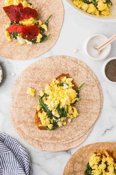 If you love the spinach feta wraps from Starbucks like I do, then you’ll love my copycat version (which uses the whole egg instead of just egg whites)! These easy breakfast wraps are stuffed with fluffy scrambled eggs, spinach, melty feta cheese, and optional roasted red peppers. They come together quickly and are freezer-friendly, so they're a perfect meal prep breakfast! Spinach Feta Breakfast Wrap, Scrambled Egg Wrap, Easy Breakfast Wraps, Spinach Feta Wrap Starbucks, Meal Prep Spinach, Scrambled Eggs Spinach, Spinach Scrambled Eggs, Spinach Feta Wrap, Freezable Meal Prep