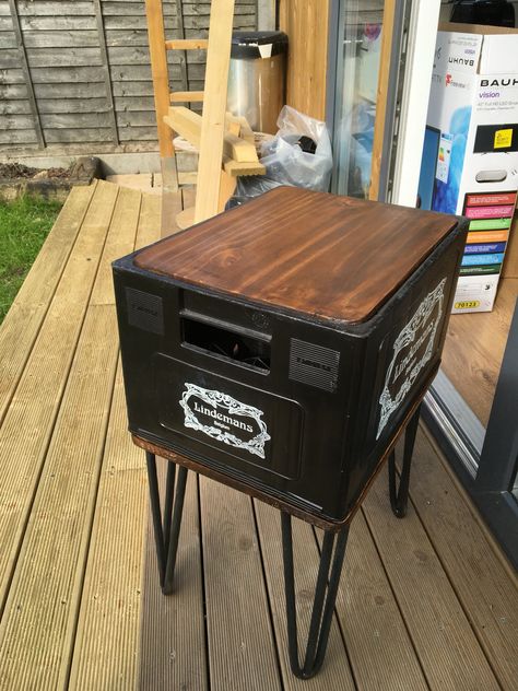 Side table made with some cast iron legs and an empty plastic beer crate Milk Crate Table Diy, Plastic Crate Furniture, Beer Crate Ideas, Plastic Beer Crate Ideas, Crate Shelves Bathroom, Coke Crate Decor, Wooden Coke Crate Ideas, Milk Crate Shelves, Old Coke Crate Ideas Wooden Boxes