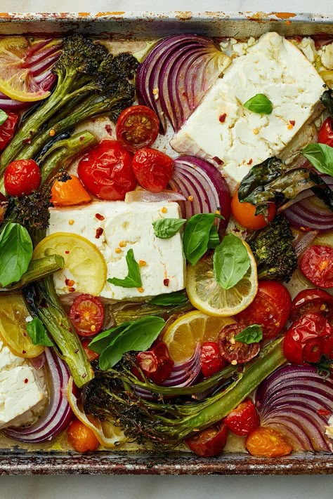 NYT Cooking: When baked, feta gains an almost creamy texture, similar to goat cheese but with feta’s characteristic tang. In this easy vegetarian sheet-pan dinner, broccolini (or broccoli), grape tomatoes and lemon slices roast alongside the feta until the broccolini crisp, the tomatoes burst and the lemon rinds soften. (Remember, broccolini has a tender, delicious stalk so only the bottom 1/2-inch needs to... Baked Feta With Vegetables, Chicken Feta Broccoli Sheet Pan, Roasted Feta Veggies, Sheet Pan Dinners Vegetarian, Sheet Pan Feta, Vegetarian Sheet Pan Dinners, Mediterranean Sheet Pan Dinners, Crisp Gnocchi, Vegetarische Diners