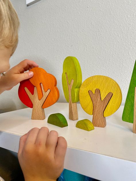 These handmade trees are perfect for building forests and cities and reimagining fairy tales. This set of hand-made wooden trees will be a wonderful addition to any nature table or play space and fit perfectly into any Montessori playtime! They are fun and colorful seasons! The set includes 4 trees & 2 bushes. Each tree comes in 2 parts, the largest tree comes in 3. CARE: Can wash with soapy water and a damp cloth Dry immediately Do not submerge in water Do not use disinfectant or hot water Toy Tree, Simple Wood Toys, Tree Toy, Handmade Montessori Toys, Handmade Tree, Season Tree, Wood Handmade Ideas, Wooden Children's Toys, Wooden Kids Toys