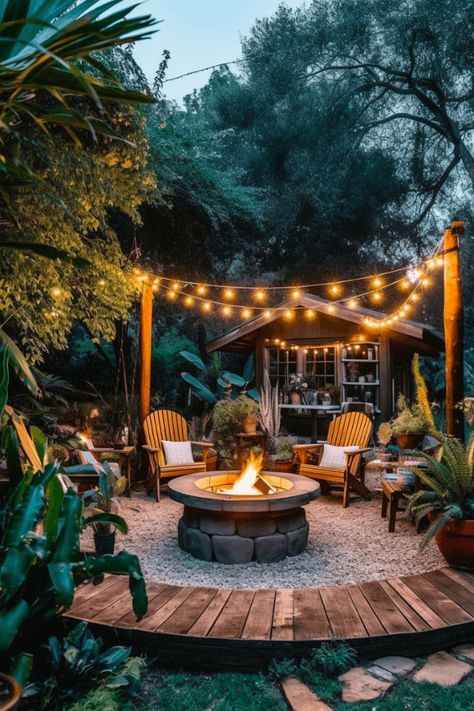 Gather around a cozy fire pit with warm string lights above. This is a great way to add some extra warmth and light to your backyard. #Backyard #GardenLife #Summer Camp Fire Pit Ideas, Fire Patio Ideas, Fire Pits With String Lights, Small Patio With Lights, Fire Places Outdoor Patio, Cozy Outdoor Fire Pit, Lights Over Fire Pit, Back Yard String Lights Outdoor, Outdoor Fire Pit Area With Lights