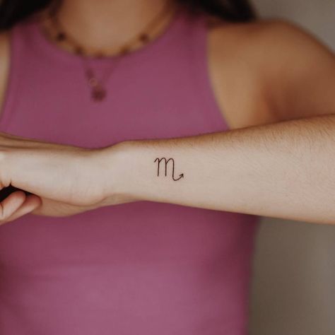 Minimalist Scorpio zodiac symbol tattoo on the wrist. Scorpio Tattoo Minimalist Women, Scorpio Zodiac Symbol Tattoo, Minimalist Scorpio Tattoo Zodiac Signs, Small Scorpion Tattoo Woman Zodiac, Scorpio Symbol Tattoo For Women, Scorpio Wrist Tattoo, Scorpio Tattoo Wrist, Scorpio Tattoo Minimalist Symbols, Scorpio Zodiac Tattoos For Women