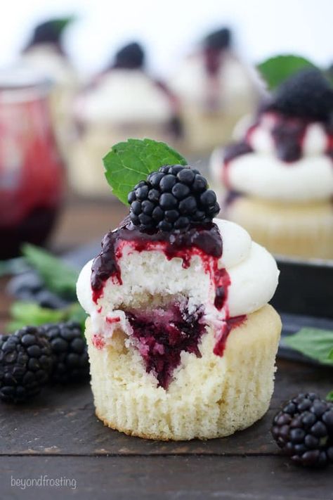 These Blackberry Bourbon Smash Cupcakes are vanilla bourbon cupcakes with a blackberry mint infused filling and topped with a vanilla bean buttercream. #cupcakes #blackberry #blackberrycupcakes #bourbon #bourboncupcakes #blackberrybourbon #homemadecupcakes Vanilla Cupcake With Filling, Berry Filled Cupcakes, Cupcakes With Fruit On Top, Fruit Filled Cupcakes, Blackberry Bourbon Smash, Bourbon Cupcakes, Cupcakes Rellenos, Blackberry Cupcakes, Blackberry Bourbon