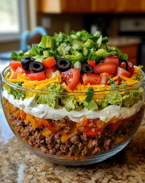 Layered with fresh veggies, cheese, and zesty taco flavors, this Seven-Layer Taco Salad is a fun, delicious, and crowd-pleasing twist on a classic favorite! 🌮🥗 #TacoSalad #LayeredSalad #PartyFood #MexicanCuisine Layer Taco Salad, Fiesta Salad Recipe, Layered Taco Salads, Taco Salad Ingredients, Fiesta Salad, Southwest Recipes, Taco Salad Recipe, Layered Salad Recipes, Taco Salad Recipes