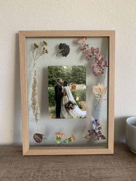 Dried wedding flowers in a wooden press for 2 months and then framed them with a wedding photo Photo Display Gift Ideas, Flowers In Picture Frames Diy, Photo Frame Flowers, Dried Flowers In Photo Frame, Picture Frame With Dried Flowers, Flowers Pressed In Frame, Flowers In Photo Frame, Wedding Flowers Dried Framed, Pressed Flowers Framed With Picture