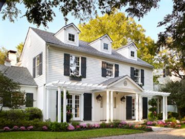 Turner Duncan and Kimberley Miller are joined at the hip. And their home is a lovely reflection of their passion for a life less ordinary. White House With Black Shutters, Colonial Portico, Colonial Curb Appeal, Colonial Front Porch, House With Black Shutters, Colonial Front Door, Colonial Porch, Garrison Colonial, Tri Level House