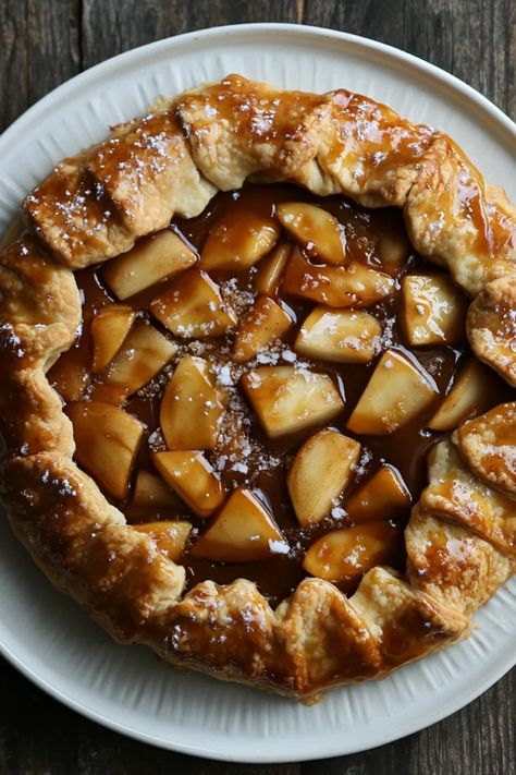 Indulge in a delectable rustic salted caramel apple galette, featuring a flaky crust filled with sweet apples and topped with warm caramel. Perfect for dessert lovers, this delightful recipe mixes comforting flavors with seasonal ingredients. The pin includes one image showcasing this stunning pie. Apple Galette With Pillsbury Pie Crust, Rustic Galette, Caramel Apple Galette, Sunday Desserts, Apple Galette Recipe, Apple Tartlets, Apple Tarte, Traditional Turkey, Apple Tarts