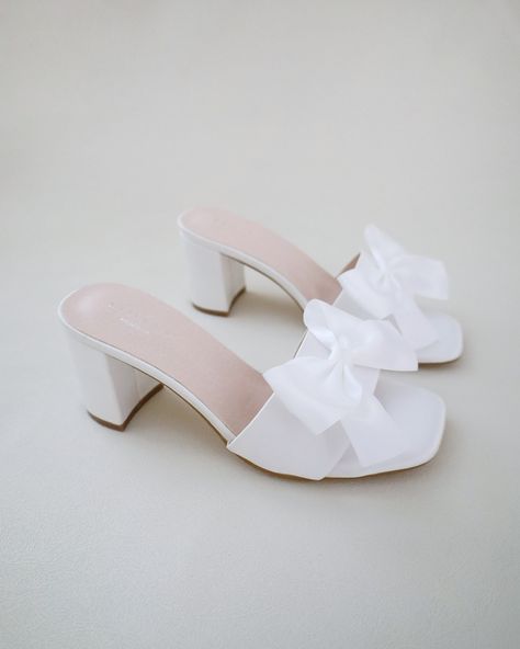 "Classic satin slip on block heel sandals for casual and dressy look. Style with satin bow at the front that adds a romantic touch, or without the bow for a classy simple style. Comfortable and easy wear for bridal wear, bridesmaids, holiday party, wedding parties, and any special occasions.  DETAILS: HEEL HEIGHT: 2.5 Inches COLORS AVAILABLE: Ivory and White UPPER: Synthetic upper and lining MATERIALS: Manmade outsole STYLE NAME: VERONA Not sure of which size to purchase? Shoes measurements are Bridesmaids Sandals, Block Heels Wedding, Bridesmaid Sandals, Sandals With Bow, Sandals Wedding, Short Heels, Bridal Sandals, Cute Heels, Block Heel Sandals