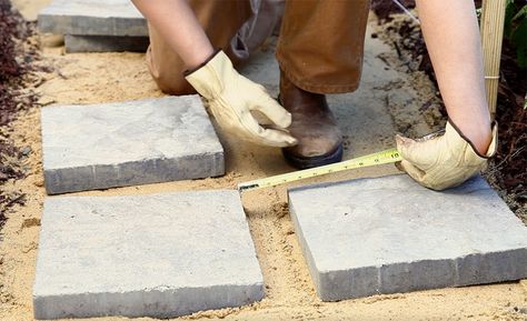 A person laying out paver stones. Laying Pavers, Pea Pebbles, How To Lay Pavers, Paver Path, Push Broom, Paver Walkway, Paver Stones, Landscape Elements, Home Backyard