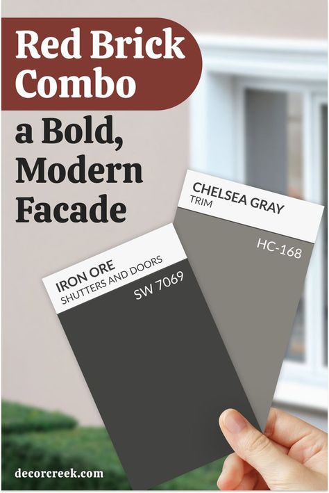 This image features the title "Red Brick Combo: a Bold, Modern Facade" with two paint color cards prominently displayed:

Iron Ore (SW 7069) for shutters and doors, a deep, bold charcoal gray.
Chelsea Gray (HC-168) for trim, a sophisticated medium gray.
The cards are held in a hand, positioned against a neutral exterior backdrop with blurred greenery and a window, highlighting the modern and polished design. Modernize Red Brick House, Red Brick And Grey House Exterior, Red Brick Accent Colors, Red Brick Bungalow Exterior, Red Brick House With Black Trim, Dark Red Brick House Exterior, Red Brick Black Windows, Red Brick Homes Exterior, Brown Brick House Exterior Color Schemes