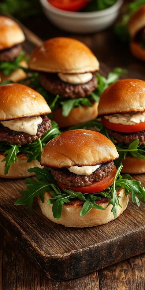 These Savory American Beef Mini Burger Sliders are the perfect bite-sized treats for any gathering! Juicy beef patties nestled between soft, buttery buns, fresh arugula, and a drizzle of creamy dressing make these sliders an instant hit. Whether it's game day or a casual get-together, these delightful sliders will steal the show! Try the recipe now and watch them disappear! Slider Ideas For Party, Sliders For Kids, Mini Burger Sliders, Sliders Burger, Burger Mini, Mini Burgers Sliders, Fancy Burgers, Burger Sliders Recipes, Gourmet Hamburgers