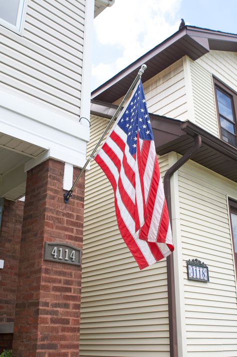 I'm boosting our home's curb appeal through DIY projects. Here's how to install a flag pole into brick in less than 10 minutes. #flagpole Hanging Flags On House Front Porches, Hanging Flag On House, Flag Pole On House, Flag On House, Easy Curb Appeal, Flag Pole Bracket, Window Boxes Diy, Add Curb Appeal, Hanging Flags