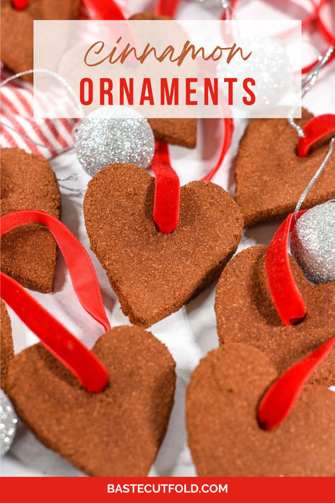 An easy cinnamon ornament recipe made with applesauce, ground cinnamon, and table salt. These three-ingredient ornaments make a fun homemade Christmas gift! Cinnamon Ornament Recipe Easy, No Cook Cinnamon Ornaments, Cinnamon Homemade Ornaments, Cinnamon Scented Playdough, Ornament Clay Recipe, Cinnamon And Glue Ornaments, Homemade Cinnamon Ornaments Recipe, Cinnamon Ornaments No Applesauce, Applesauce And Cinnamon Ornaments Recipe