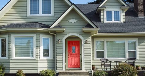 Having a green house may seem intimidating when it comes time to coordinate the colors for your exterior, such as the door. If you’re wondering what c... | 13 Flirt Alert scaled Green House Siding, Green Siding House, Light Green House, House Doors Colors, Green House Color, Sage Green House, Exterior Front Door Colors, Green Exterior Paints, Green Exterior House Colors