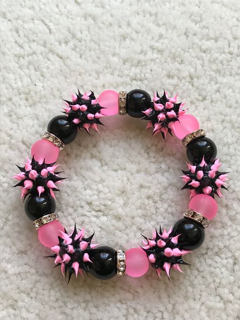 Bring back the 70's with this Disco inspired Neon pink/Black Rubber Spike Bracelet surrounded by an array of crystal spacers and large glass beads!      It stretches to fits up to a 8.0" wrist.  It can be custom made to fit smaller and larger sized wrists.  Comes wrapped in a gift giving bag with tie. In stock items ship within 2-3 business days.  Custom orders can take up to 10 days. All of my items are carefully packaged and sent in a box or bubble mail envelope. Shipping Time - Please allow 3 Mail Envelope, Spike Bracelet, Kandi Bracelets, Scene Fashion, Dope Jewelry, Fabric Accessories, Funky Jewelry, Black Bracelets, Black Jewelry