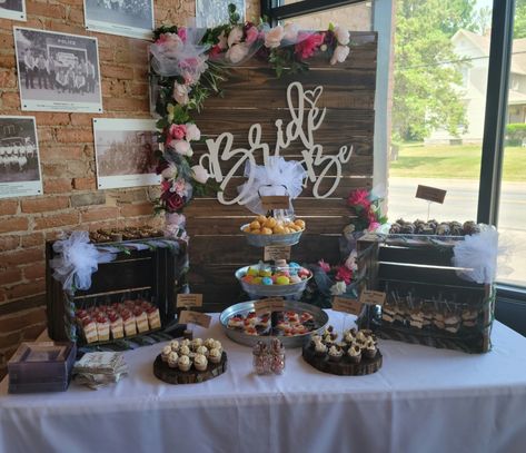 Bridal Shower dessert table, brownies, shooters, cheesecake and cup cakes.  Rustic bridal shower.  Flowered bridal shower ideas.  Pink, white, wine colors. Western Bridal Shower Ideas Decor, Highland Cow Bridal Shower Ideas, Boots And Bubbly Bridal Shower Decor, Last Rodeo Bridal Shower Ideas, Western Theme Bridal Shower Ideas, Bridal Shower Rustic Theme, Rustic Bridal Shower Ideas Decorations, Boots And Bubbly Bridal Shower Ideas, Bridal Shower Ideas Pink