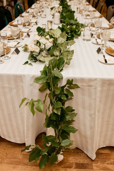 Salal garland greenery runner displayed on the head table Purdue Memorial Union, Indiana wedding Head Table Garland, Greenery Runner, Garland Table Runner, Table Garland, Indiana Wedding, Greenery Garland, Flower Studio, Ceremony Flowers, Head Table