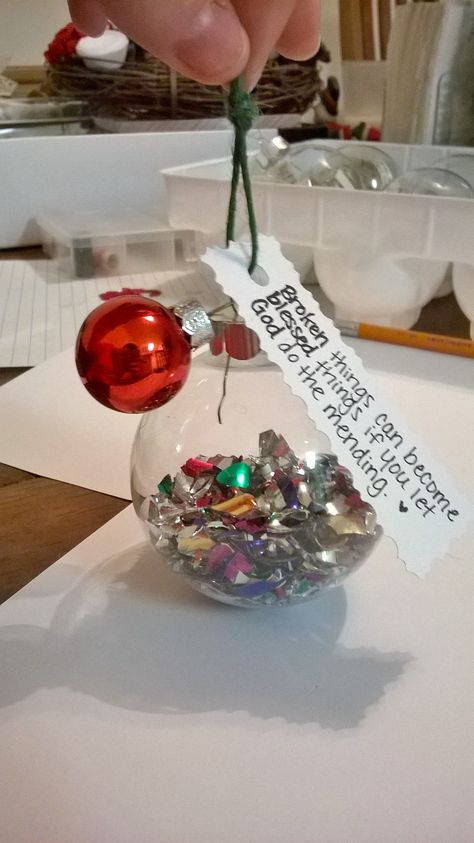 Homemade Christmas Ornament. Glass ball filled with broken shards of ornaments adorned with a mini ornament and a tag that reads "Broken things can become blessed things if you let God do the mending". Easy ornament with a fantastic message. Home Made Christmas Ornaments Glass Balls, Old Christmas Balls Repurpose, Broken Ornament Crafts, Filled Ornament Ideas, Upcycle Christmas Ornament Balls, Santa Ornaments Diy Glass Ball, Clear Ornaments Diy Homemade Christmas Glass Ball, Homemade Christmas Ornament, Ornament Glass Ball