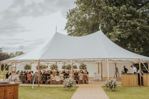 This medium sailcloth tent has a mix of white and clear sides, with the clear sides rolled up to make the most of the weather. Other finishing touches from Events Under Canvas, matted walkway, fire pit, circular bar, cross back chairs rustin tables and dance floor. Events Under Canvas We've got spectacular covered Events Under Canvas, Decorate Tent For Wedding, Sailcloth Wedding Tent, Canvas Tent Wedding, Sailcloth Tent Wedding, Tent Flooring, Sail Cloth Tent, Tent Entrance, Circular Bar