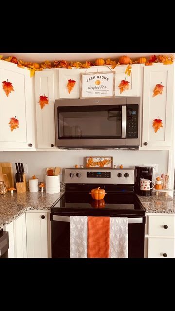 Courtney Santos on Instagram: "Fall kitchen 🎃🍄🍁🍂 #fallkitchen#autumnkitchen#autumn#falldecor#decor#fallgarland#diyfalldecor#pumpkins#leaves#pumpkindecor#favoriteseason#diyhomedecor#fall#diydecor#cozy#homedecor." Fall Above Cabinet Decor Kitchen, Above Kitchen Cabinet Halloween Decor, Seasonal Kitchen Decor, Fall Decorations Above Kitchen Cabinets, Mobile Home Fall Decor, Above Kitchen Cabinet Fall Decor Ideas, Fall Kitchen Decor Ideas Diy, Fall Decor Kitchen Cabinets, Fall Kitchen Cabinet Decor Ideas