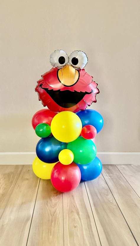 Welcome to Oh How Charming! Looking to make a statement at your next party? A balloon tower is the way to go! This will definitely make your guests say WOW!  The tower is the perfect accent to any event, use is at the party entrance, next to a high chair, cake table..the possibilities are endless! Each kit includes everything needed to create your very own balloon column. I know it looks intimidating, but no balloon experience is required!  And NO HELIUM is used, this is created using air only!! Elmo Birthday Decorations Diy, Sesame Street Balloon Columns, Elmo Balloon Column, Elmo Birthday Balloons, Elmo Party Ideas Decoration, Elmo Balloon Bouquet, Sesame Street Birthday Balloons, Halloween Elmo Party, Elmo Bday Party Ideas