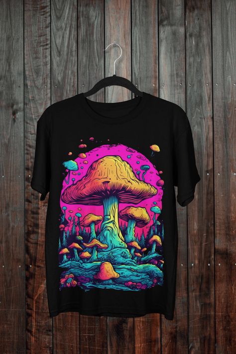 The trippy mushroom T-shirt in black is a mesmerizing piece of wearable art designed for both men and woman. Featuring a captivating fantasy art motif, this tee embodies a blend of hippie, retro, and vintage vibes. Its eye-catching design showcases intricate mushrooms, creating a visually stunning and mind-bending experience. Crafted with style and comfort in mind, this shirt is the perfect addition to any free-spirited individual's wardrobe. Trippy Shirt Design, Mushroom Land, Trippy Mushroom, Mushroom T Shirt, Hippie Shirt, Art Shirt, Trippy Art, Free Spirited, Art Shirts