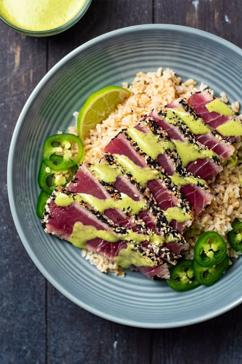 Pan seared ahi tuna has always been one of my favorite seafood dishes. My recipe features a sesame crusted ahi tuna (yellowfin or bigeye) that is crispy on the outside with a melt-in-your-mouth, raw interior. If you're a sushi lover, this recipe is absolutely for you. I like to serve pan seared tuna over jasmine or brown rice and top with both spicy cilantro-lime aioli and soy sauce. #pansearedtuna #searedtuna #ahituna #sesamecrustedtuna Cilantro Lime Aioli Recipe, Ahi Recipes, Seared Ahi Tuna Recipe, Seared Tuna Recipe, Sesame Seared Tuna, Ahi Tuna Steak Recipe, Tuna Steak Recipe, Sesame Crusted Tuna, Ahi Tuna Recipe