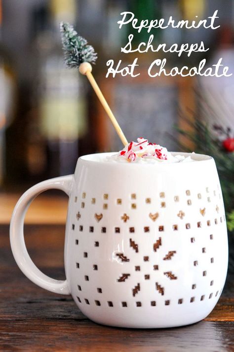 Peppermint Schnapps Hot Chocolate in a white mug, pine tree stirrer, evergreen branch behind Peppermint Snapps Drinks, Homemade Peppermint Hot Chocolate, Peppermint Hot Chocolate Cocktail, Peppermint Spoons For Hot Chocolate, Peppermint Schnapps Hot Chocolate, Warm Winter Cocktails, Peppermint Hot Chocolate Recipe, Thanksgiving Cocktail Recipes, Spiked Hot Chocolate