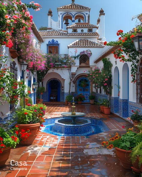 Step into elegance with this Spanish patio showcasing a beautiful mosaic fountain and lush greenery. The intricate tile work and blooming flowers create a picturesque setting. Follow CasaCampera for inspiring patio designs! Outdoor Spanish Tile, Spanish Patio Ideas, Spanish Garden Ideas, Spanish Style Patio, Spanish Style Courtyard, Spanish Gardens, Mexican Courtyard, Spanish Patio, Mosaic Fountain