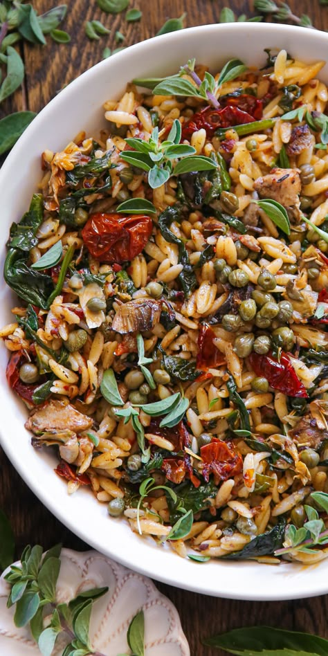 Sun-Dried Tomato Orzo with Spinach, Artichokes, and Capers - in a white bowl. Orzo With Capers, Easy Meat Dishes Dinners, Mediterranean Diet Artichoke Recipes, Orzo Bowl Recipe, Spinach Tomato Orzo Pasta, Leftover Orzo Recipes, Healthy Vegetarian Salads, Winter Orzo Salad Recipes, Fall Orzo Recipes