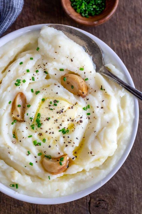 Roasted garlic mashed potatoes are a savory twist on a classic side dish. The garlic adds a soft buttery consistency with a light caramelized flavor. #garlic #mashedpotatoes #sidedish #roastedgarlic Cauliflower Mashed Potatoes Recipe, Nostalgic Recipes, Yummy Potatoes, Cauliflower Mashed, Mashed Cauliflower Recipe, Frozen Cauliflower, Parmesan Cauliflower, Potatoes Roasted, Delicious Sides