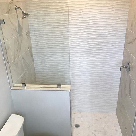 White wavy tile makes for a fun summer inspired guest bath. #tilebar #tiledesign Wave Shower Tile Ideas, Wavy Tile Bathroom, Wavy Bathroom Tile Showers, Wave Shower Tile, Wavy Tile Bathroom Showers, Wave Bathroom Tile Shower Walls, White Wavy Tile Shower Master Bath, Tile Bathroom Design, White Wavy Tile