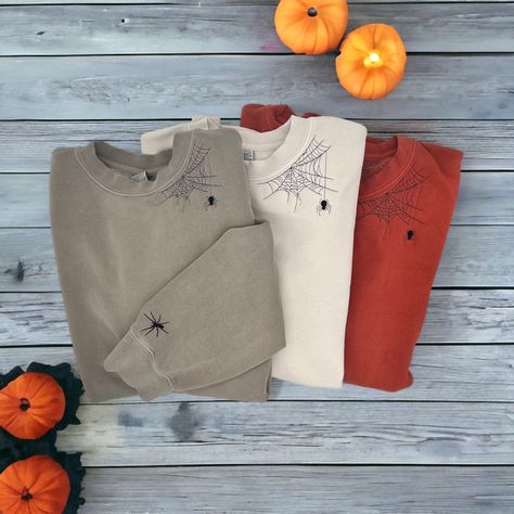 Are you ready for Spooky Season? Get ready with this embroidered spiderweb crewneck. Included with a crawly spider friend on your wrist to keep you company while you drink your coffee or watch your favorite scary movies.  **Color shown is Pigment Cement** ORDERING & SHIPPING *Your item will be shipped within 5-7 business days. *Please allow 2-5 business days to receive your item, more time may be necessary depending on holidays. *We do not accept returns/refunds but please reach out with any con Embroidery Halloween Sweatshirt, Embroidered Halloween Shirts, Diy Halloween Sweatshirt, Embroidered Halloween Sweatshirt, Embroidered Crewneck Diy, Halloween Embroidery Sweatshirt, Embroidered Wildflowers, Hand Embroidered Sweatshirt, Spooky Sweatshirt