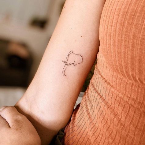 Minimalist line art elephant tattoo on the inner arm. Best Elephant Tattoo, Elephant Tattoo Line Art, Simple Line Art Tattoos For Women, Elephant Micro Tattoo, Elephant And Sun Tattoo, Tattoo Of Elephant, Minimalist Elephant Tattoo Simple, Elephant Tattoo Placement Ideas, Aesthetic Elephant Tattoo