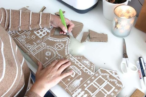 Get creative this holiday season with our DIY guide to crafting a cardboard Christmas village. Follow our step-by-step instructions to bring the magic of the holidays into your home. Christmas Village Cutouts, Gingerbread Cardboard House Ideas, Diy Ginger Bread Houses Cardboard, Gingerbread Village Template, Cardboard Gingerbread Village Diy, Cardboard Gingerbread House Village, Diy Gingerbread Village Cardboard, Gingerbread Village Cardboard, Diy Gingerbread Village Ideas