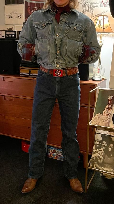 maroon handkerchief  st johns bay flannel vintage old navy dungarees jean jacket foster’s belt with 1983 NAP inc “its my air too” belt buckle wrangler jeans dan post cowboy boots   this outfit was heavily inspired by jesse welles and i assume he gets most of his outfit inspo from other artists like bob dylan :^)   #beltbuckles #cowboy #vintage #retro #vintagestyle  #1970s #1960s #70s #60s #western Ground Breaking Ceremony Outfit, Hipster Cowboy Fashion, Cliff Booth Outfit, Bob Dylan Outfit Ideas, Retro Outfits 70s Vintage Fashion Men, Queer Country Aesthetic, Cowboy Fashion Aesthetic, 80s Western Aesthetic, Retro Cowboy Outfit