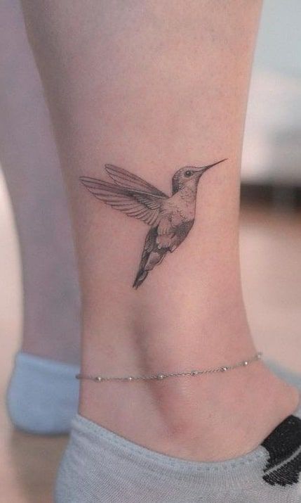 Black Ink Hummingbird Tattoo, Hummingbird Tattoo With Script, Tattoos Of Hummingbirds, Women Leaf Tattoo, Humming Bird Tattoo Wrist, Push Through Tattoo, Tattoo Of Hummingbird, Humming Tattoo Bird, Flying Hummingbird Tattoo