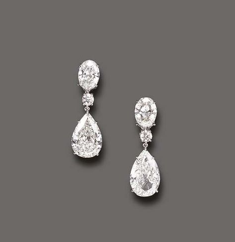 AN ELEGANT PAIR OF DIAMOND EAR PENDANTS  Each pear-shaped diamond, weighing approximately 5.07 or 5.51 carats, suspended by a circular-cut diamond spacer, to the oval-cut diamond surmount, weighing approximately 1.80 or 1.87 carats, mounted in platinum Diamond Earrings Prom, Luxury Earrings Diamond, Teardrop Diamond Earrings, Wedding Diamond Drop Earrings, Diamond Brilliant Cut Drop Earrings, Luxury Diamond Earrings, Big Diamond Earrings, Bridal Diamond Earrings, Oval Diamond Earrings