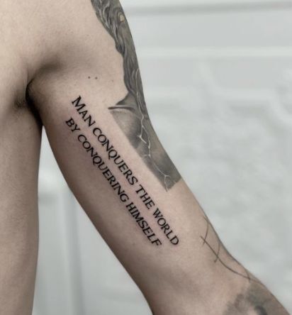 The Man Conquers Tattoo Quotes For Guys Tattoo Ideas For Men Arm Meaningful, Tattoo Designs Men Quote, Quotes For Tattoos For Guys, Tattoo Ideas Men Meaningful Arm Sleeve, Mens Quote Tattoos, Men Quote Tattoos, Meaningful Tattoo Quotes For Men, Writing Tattoos For Men, Quotes Deep Meaningful Tattoo