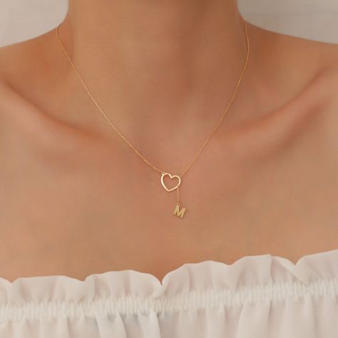 "You can buy this Letter Hanging From Heart Necklace as a unique gift for yourself or your loved ones, This precious dainty  Necklace on your neck will remind you of countless meanings and feelings that no one else can know. We know the value of every letter or name on the chain to you. We know that it will be more than a necklace for you, from the moment we receive the order for it. We produce our products with extraordinary enthusiasm and respecting the stories they contain. Remember, Your Design will be Your Story. Material; High Quality 925 Sterling Silver Color; Gold, Silver,  Rose Chain Length; 14\" , 16\" , 18\", 20\", 22\" (There is an extra 3 cm extension on the chain.) Our products are meticulously handcrafted by design and jewelry experts in our workshop, which works with advanc Heart Necklace With Initial, Mother's Day Gift Heart Pendant Name Necklace, Mother's Day Heart Pendant Name Necklace, Customized Necklace For Valentine's Day Gift For Her, Customized Pendant Necklaces For Valentine's Day, Valentine's Day Gift Name Necklace Pendant, Valentine's Day Gift Pendant Name Necklace, Heart Shaped Clavicle Chain Necklaces For Gifts, Heart Clavicle Chain Necklace For Gift